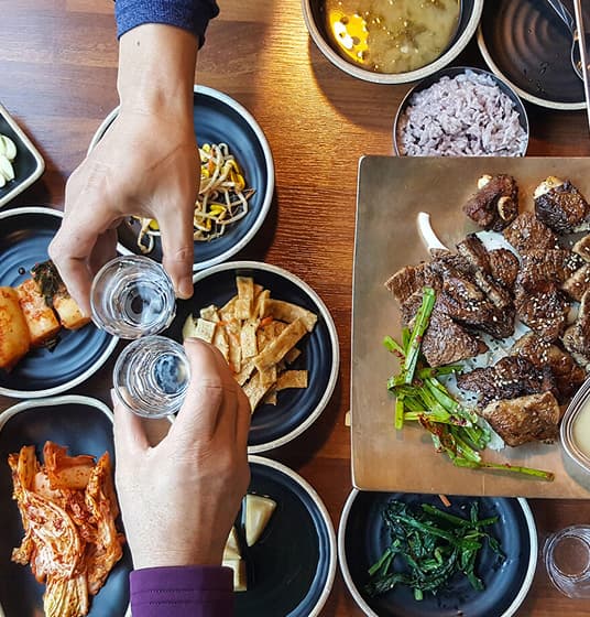 Two people toast over a meal